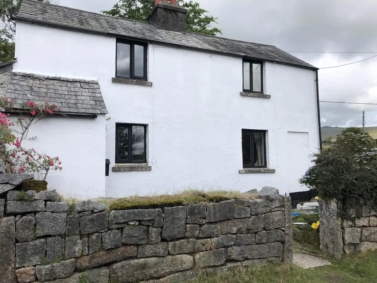 Render repair and exterior repaint of a cottage in Seaton